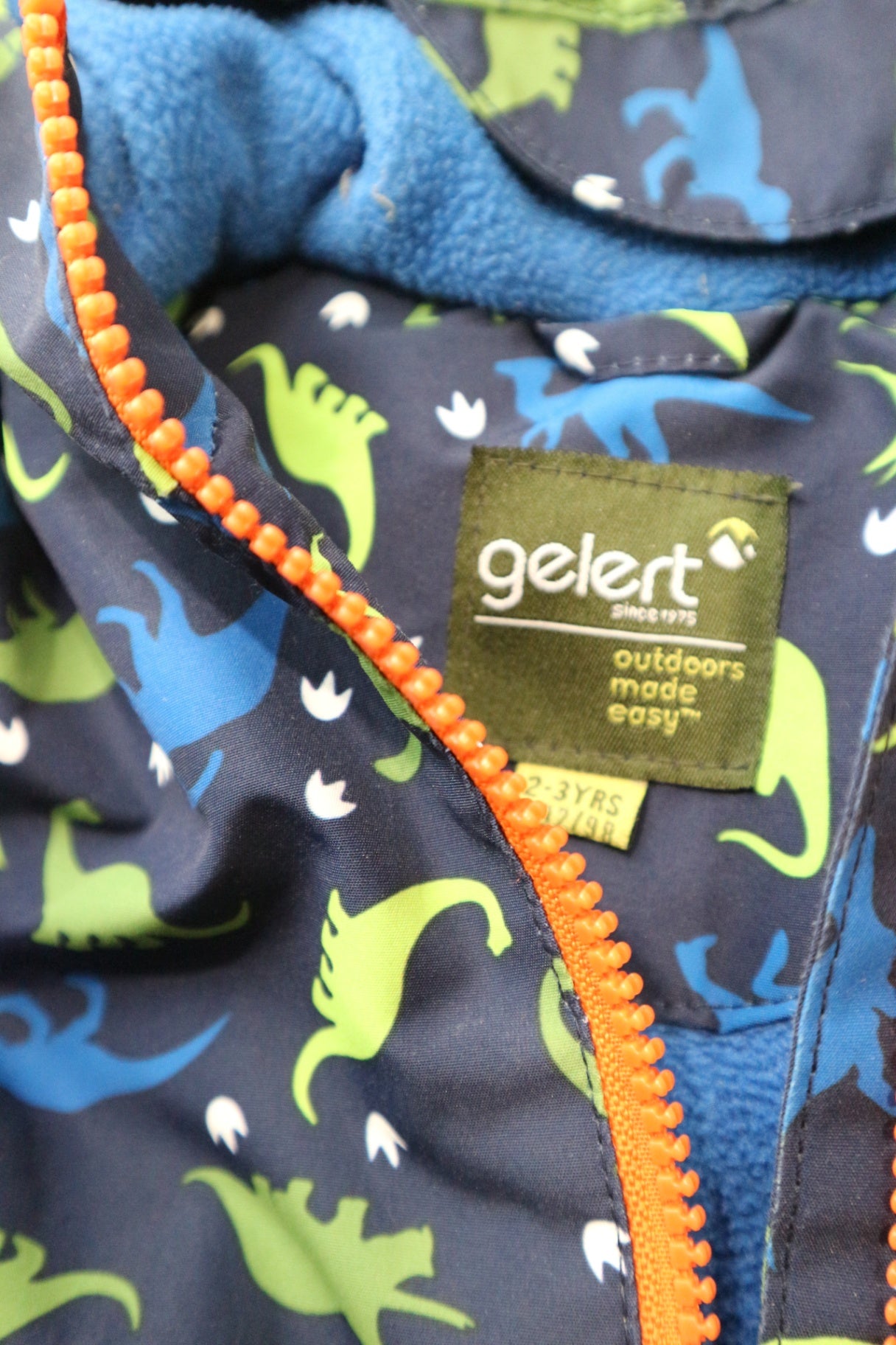 Gelert Jacket, Navy blue with green and blue dinosaur print and orange accents, 2-3